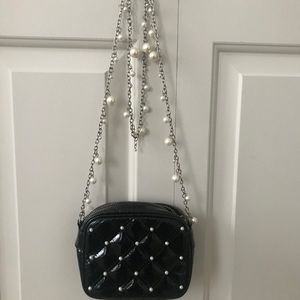 Tiny black crossbody bag with pearl details